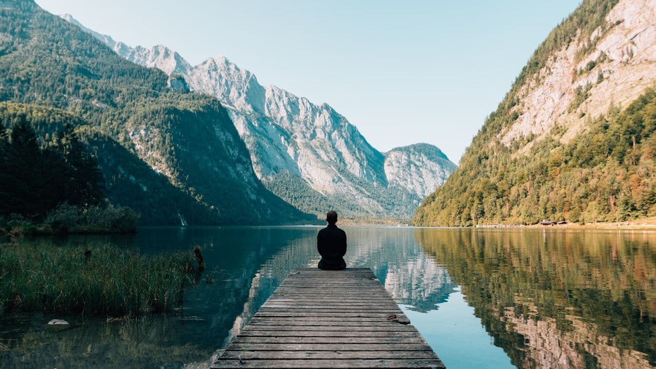 Relaxing and observing the mountain reflection in a lake